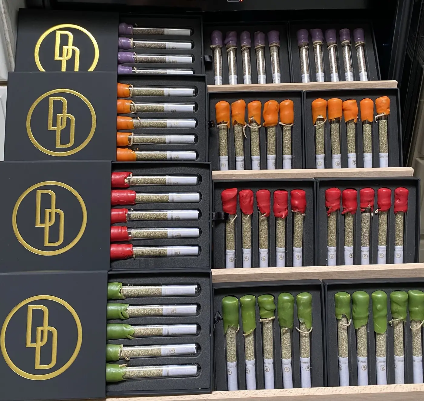PURE Preroll presentation boxes with wax-sealed glass tubes and gold DD Signature